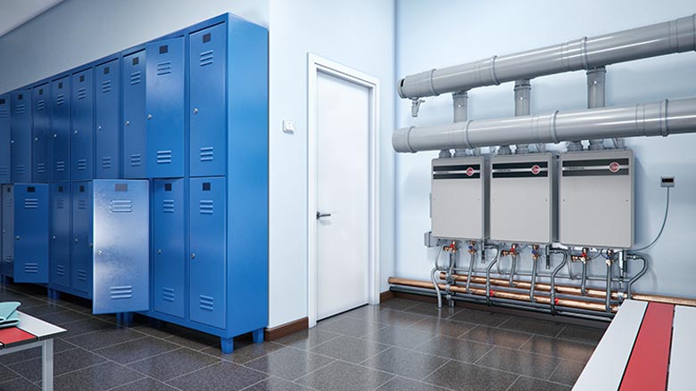 A Rheem Commercial Tankless Rack System is installed in a locker room