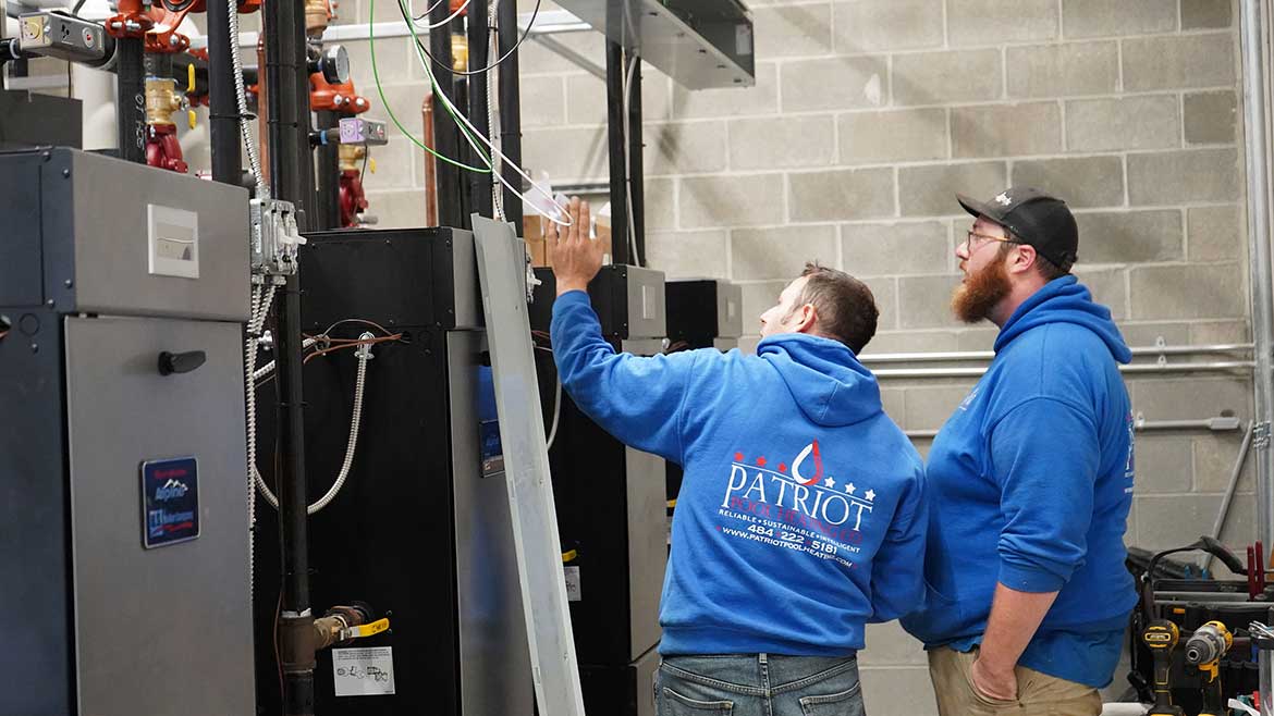 06 PM 1123 Nemacolin Woodlands Resort Patriot Water Works Service Manager Rich Zalepa and Technician Joey Mundorff calibrate high- and low-fire settings on one of the new Alpine boilers