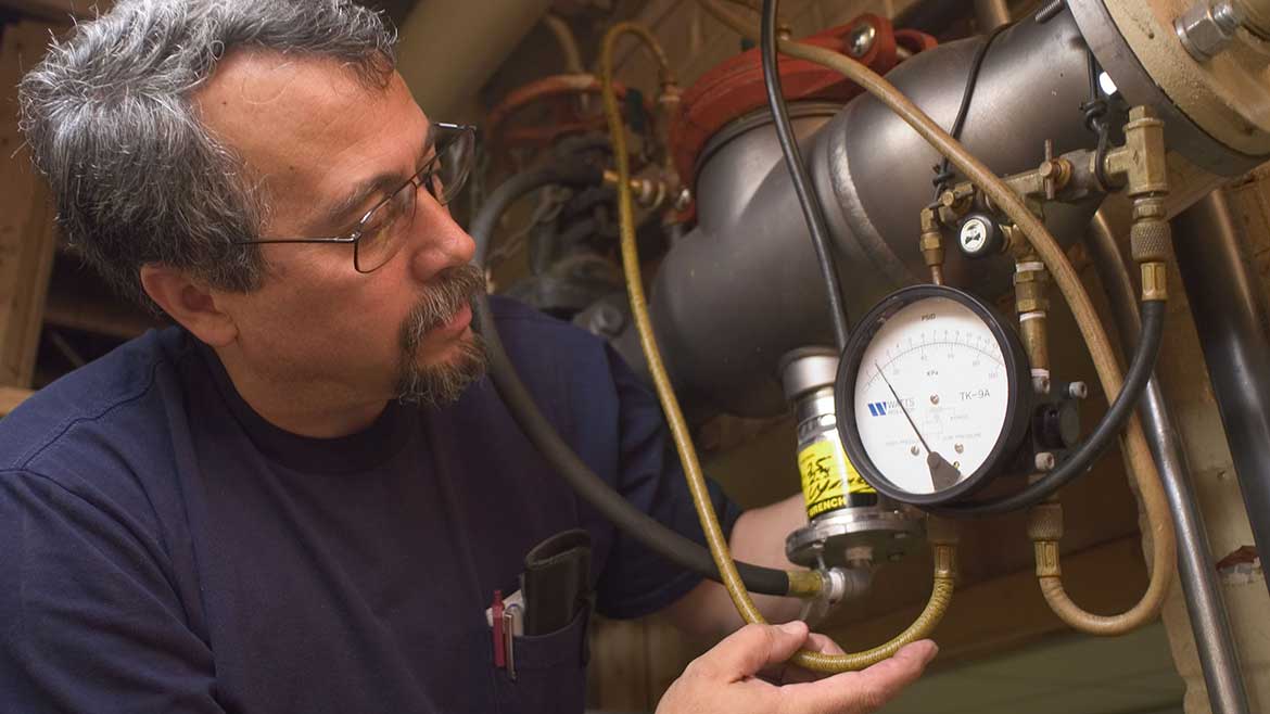06 PME 1223 Backflow Preventers New Technologies. PM and PM Engineer Columnist Dave Yates, a certified backflow tester, tests a Watts RPZ BFP check valve’s differential pressures serving a loading dock’s sprinkler system.