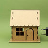 PME March 2024 John Siegenthaler Column feature image of an electric plug being plugged in to a small wooden model house. 